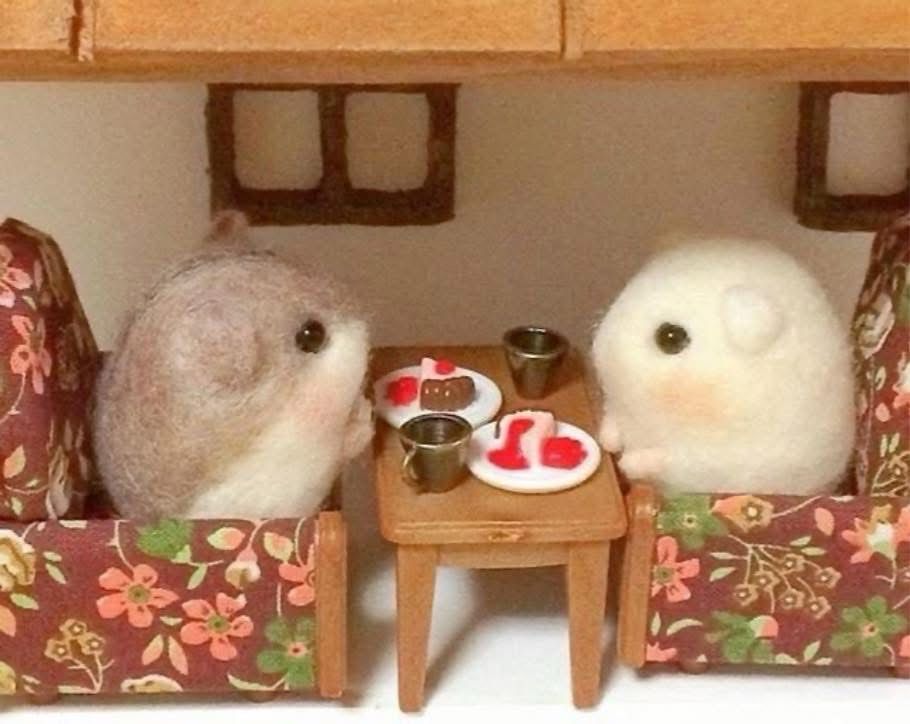 two felted hamsters sharing a meal 