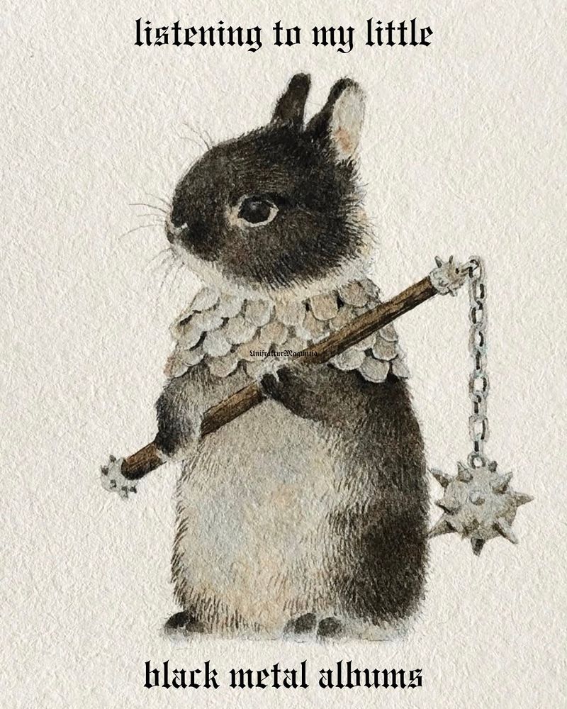 a bunny with a flail
text: listening to my little black metal albums 