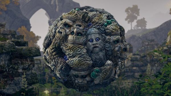 a sphere made up of stone faces floating in the air