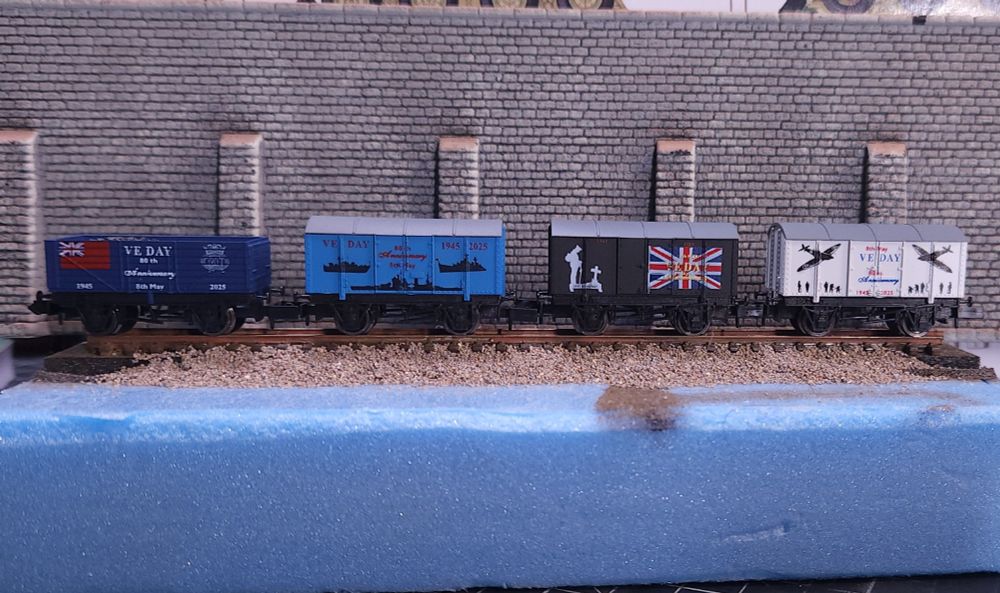 A set of four model railway wagons commemorating the 80th anniversary of VE day. 
