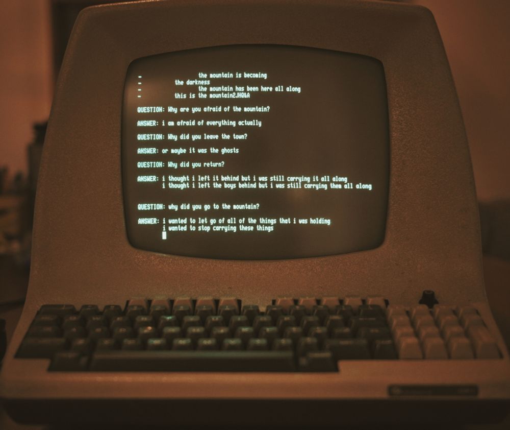 image of an old, rounded green screen computer terminal, an ADM-5, with the text:
the mountain is becoming
the darkness

the mountain has been here all along
this is the mountain
QUESTION: Why are you afraid of the mountain?
ANSwER: i an afraid of everything actually
QUESTION: Why did you leave the town?
ANSWER: or maybe it was the ghosts
QUESTION: Why did you return?
ANSWER: i thought i left it behind but i was still carrying it all along i thought i left the boys behind but i was still carrying them all along
QUESTION: why did you go to the mountain?
ANSWER: i wanted to let go of all of the things that i was holding
i wanted to stop carrying these things