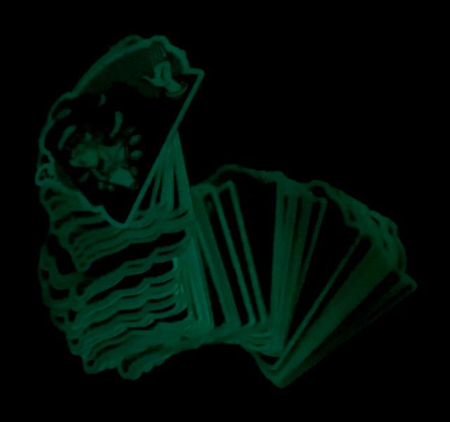 A photograph of the same stickers as the previous image, now glowing in the dark as advertised.