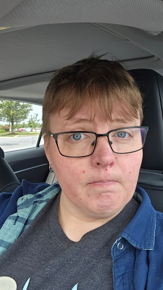 Selfie. Hair is unkempt/unwashed. I'm wearing glasses and sitting in my car.