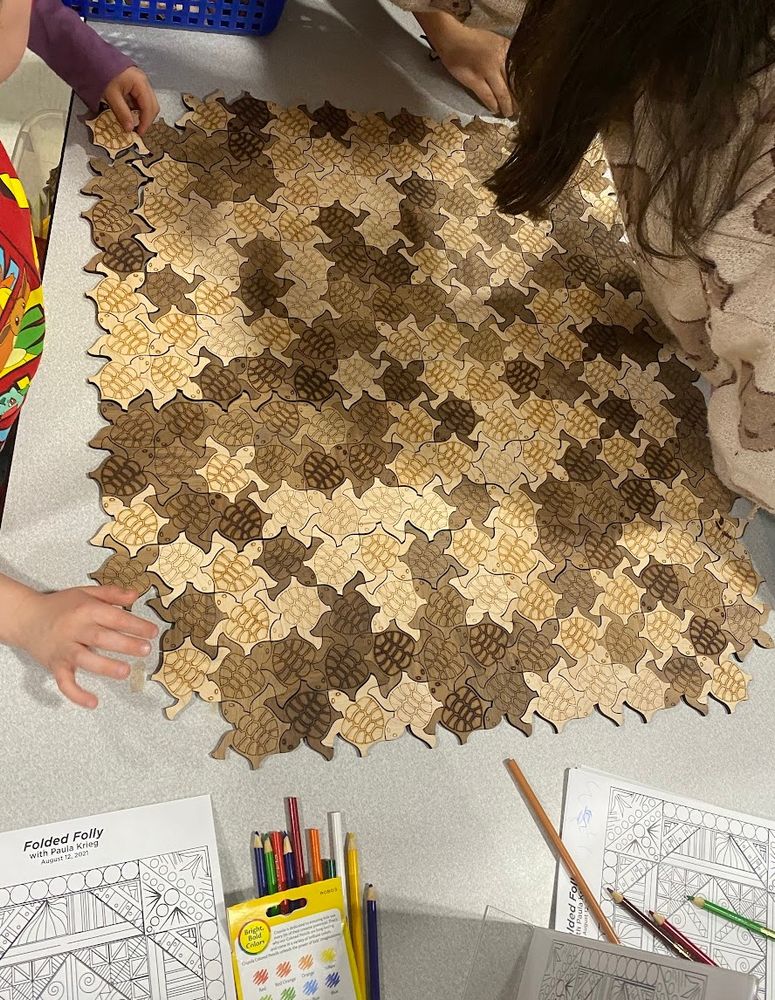 lots of tiling turtles put together on a table. 
