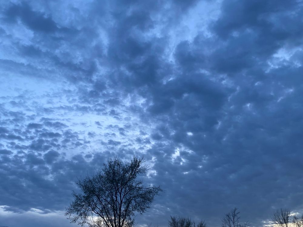big slate grey clouds in a luminous evening sky