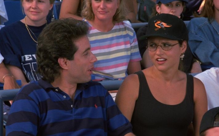 elaine benes wearing a baltimore orioles baseball cap 