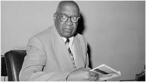 William L. Patterson at the Communist Party's New York City office, May 31, 1962. Patterson was the prime mover behind the historic 'We Charge Genocide' petition detailing the anti-Black crimes of U.S. capitalism to the UN in 1951. At the time of this photo, Patterson was one of ten Communist Party officials accused of "subversive activities" by the U.S. government, which was trying to order Patterson and others to register under the Internal Security Act. Photo credit: AP.