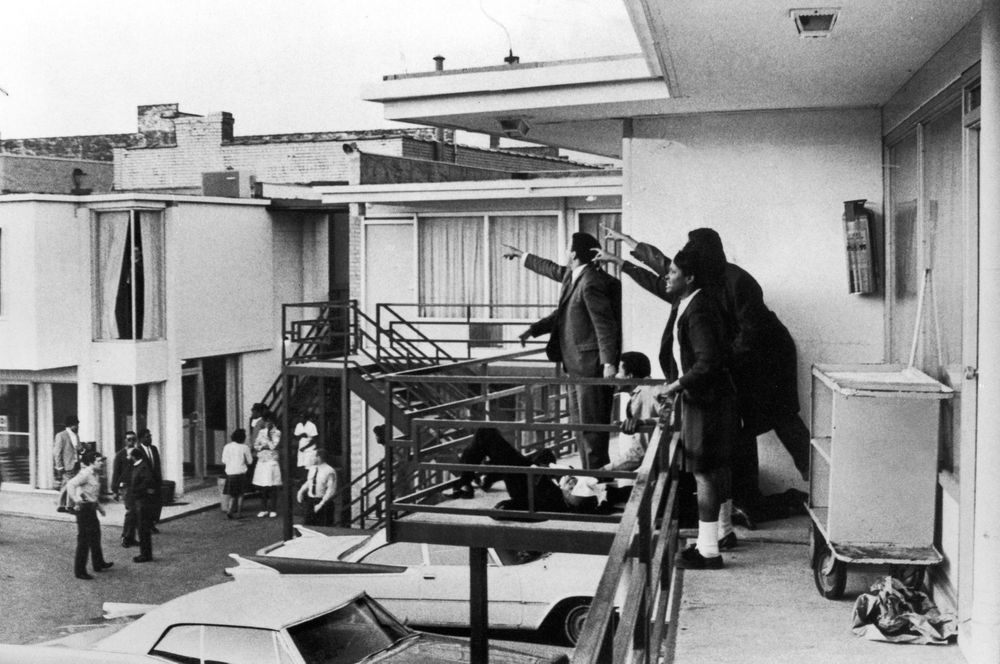 Civil rights leader Andrew Young (L) and others on balcony of Lorraine motel pointing in direction of assailant after assassination of Dr. Martin Luther King, Jr., who is lying mortally wounded at their feet. Photo credit: Joseph Louw / The LIFE Images Collection / Getty Images.