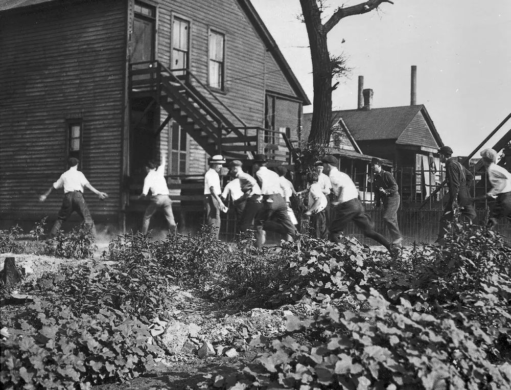 Rioters with bricks and stones in pursuit of an African American man during the Chicago Race Riot of 1919. Photo credit: Jun Fujita / Chicago History Museum, via Getty Images.