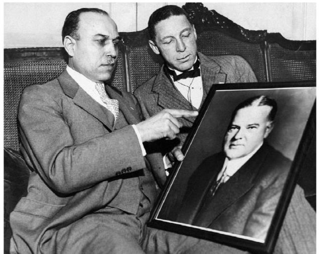 Perry W. Howard (left), the boss of the Repub party in Mississippi, pictured with Roscoe Conkling Simmons, a reporter and civil rights activist from Illinois, points at a portrait of President Herbert Hoover at the 1932 Repub National Convention. At the convention, Hoover tried to unseat Howard and his Black-and-Tan delegates and replace them with Lily Whites. Hoover failed and Howard would remain boss of the Mississippi GOP until 1980. Photo by NY Daily News Archive via Getty Images. 