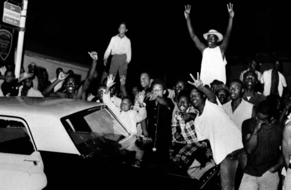 Demonstrators push against a police car after rioting erupted in a crowd of 1,500 in the Los Angeles area of Watts, triggered by the arrest of a Black person on charges of drunken driving. Photo credit: AP.