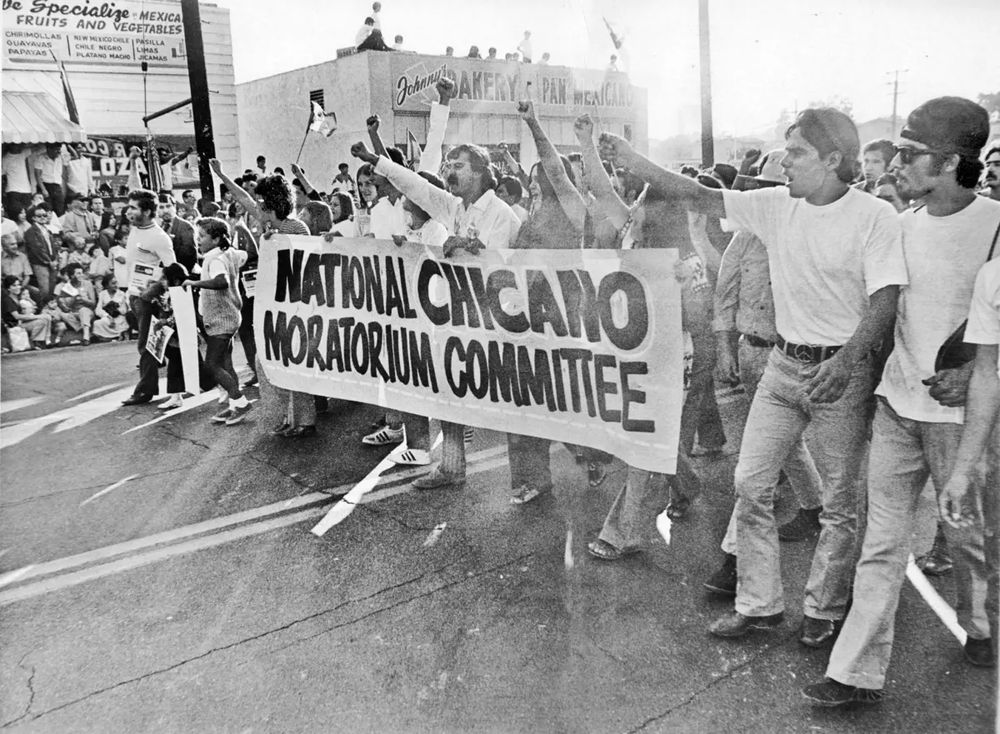 People march with a banner for the National Chicano Moratorium, 1970. Photo credit: L.A. Times.