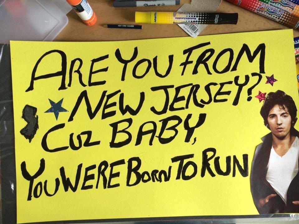 A yellow sign with big black lettering that reads "Are you from New Jersey? Cuz baby, you were born to run" with a small drawing of the state of New Jersey and a cut out of Bruce Springsteen.