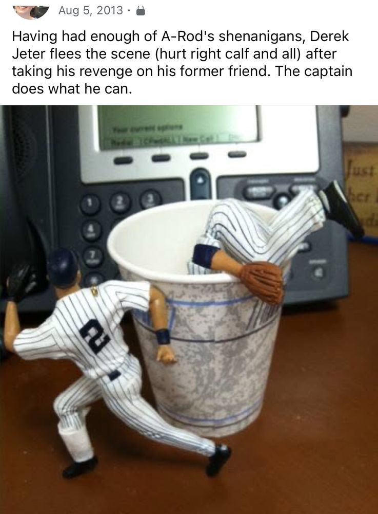 A photo from Aug. 5 2013 showing the Derek Jeter Hallmark Christmas ornament "sprinting" away after having knocked the Alex Rodriguez ornament facedown into a cup of water, leaving A-Rod's legs dangling over the side. The text with the post reads: "Having had enough of A-Rod's shenanigans, Derek Jeter flees the scene (hurt right calf and all) after taking his revenge on his former friend. The captain does what he can."
