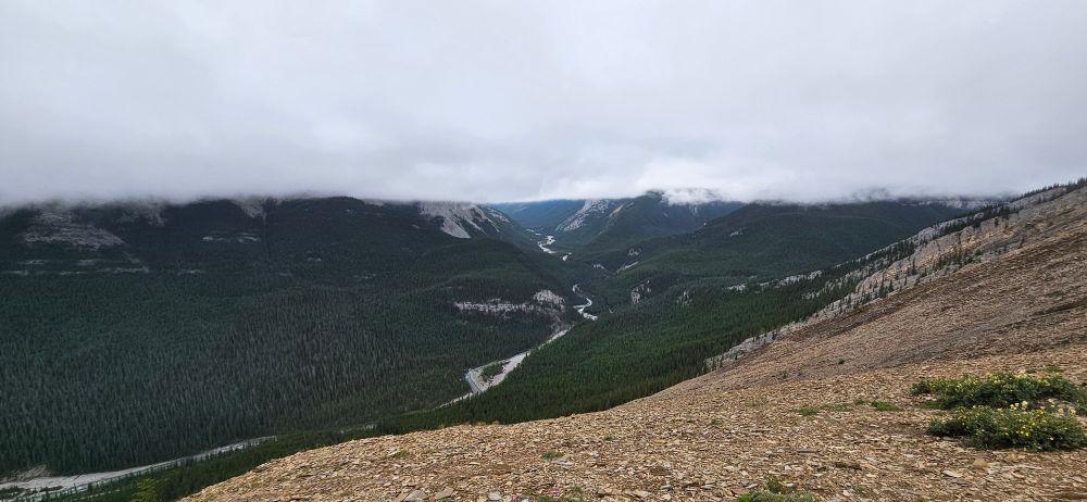 A view from a ridge into the elbow river valley under low clouds