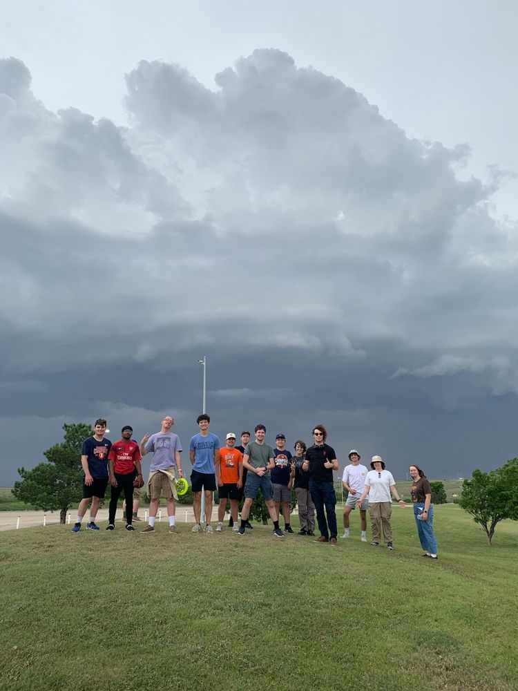 Students standing in front of a shelf cloud