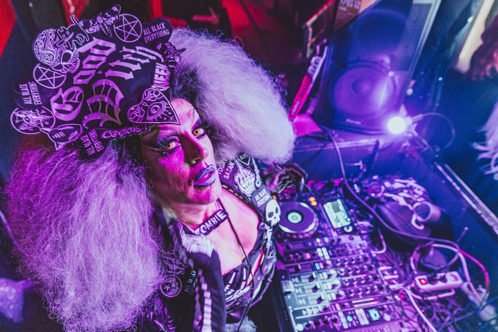 Sylvia Slut en drag posant devant ses platines 