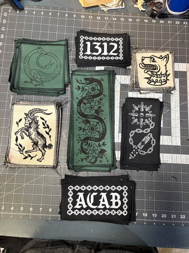 A selection of screen printed patches on a work table 