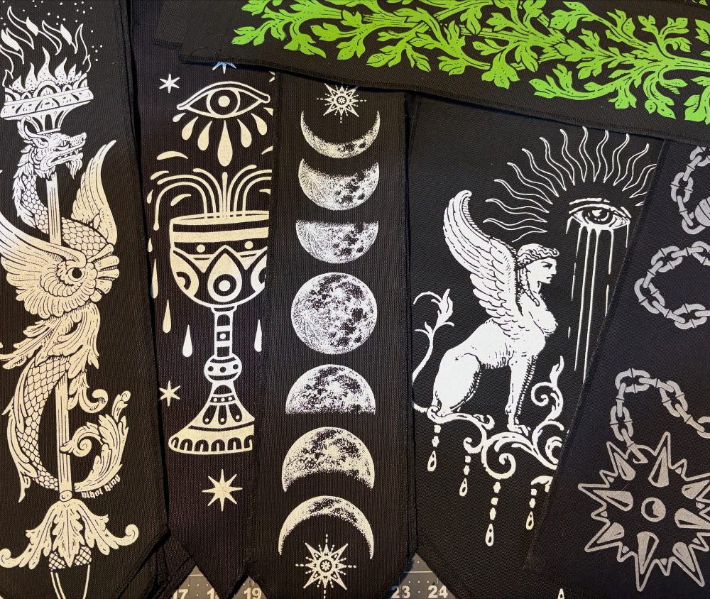 A variety of black banners with different designs on them. 