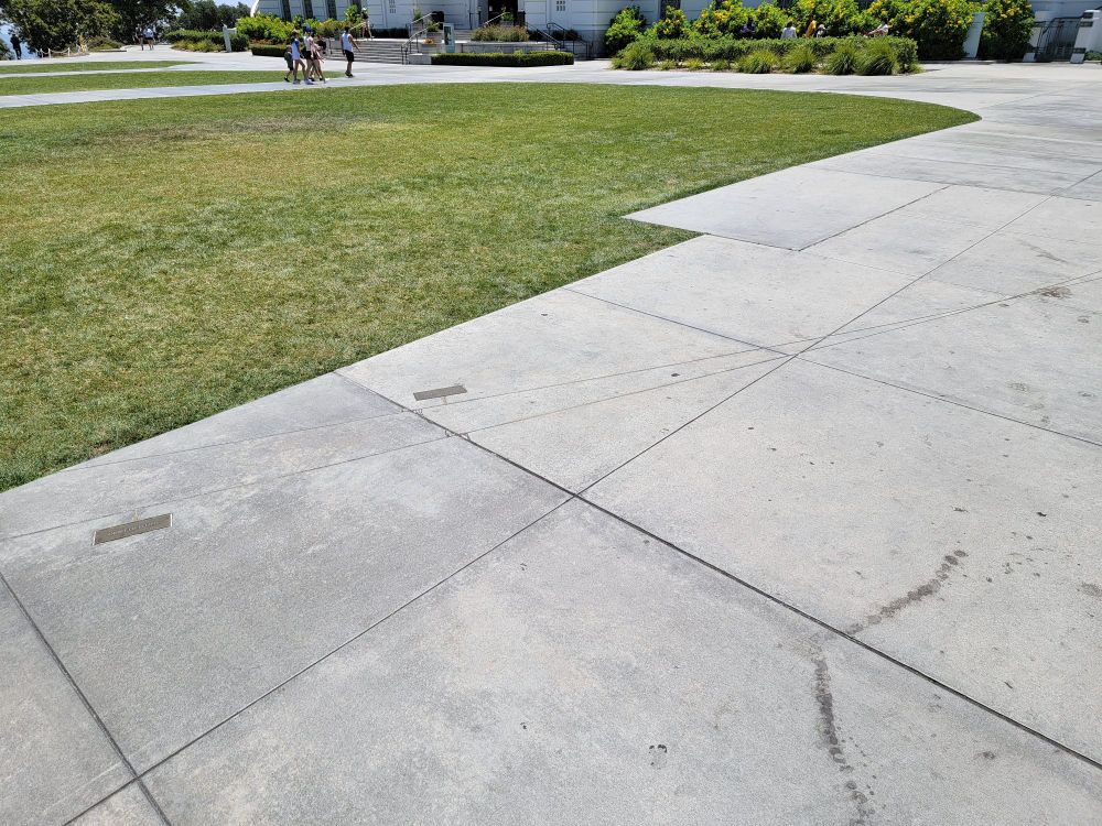 the griffith observatory grounds' scale model depiction of the orbits of neptune and pluto intersecting