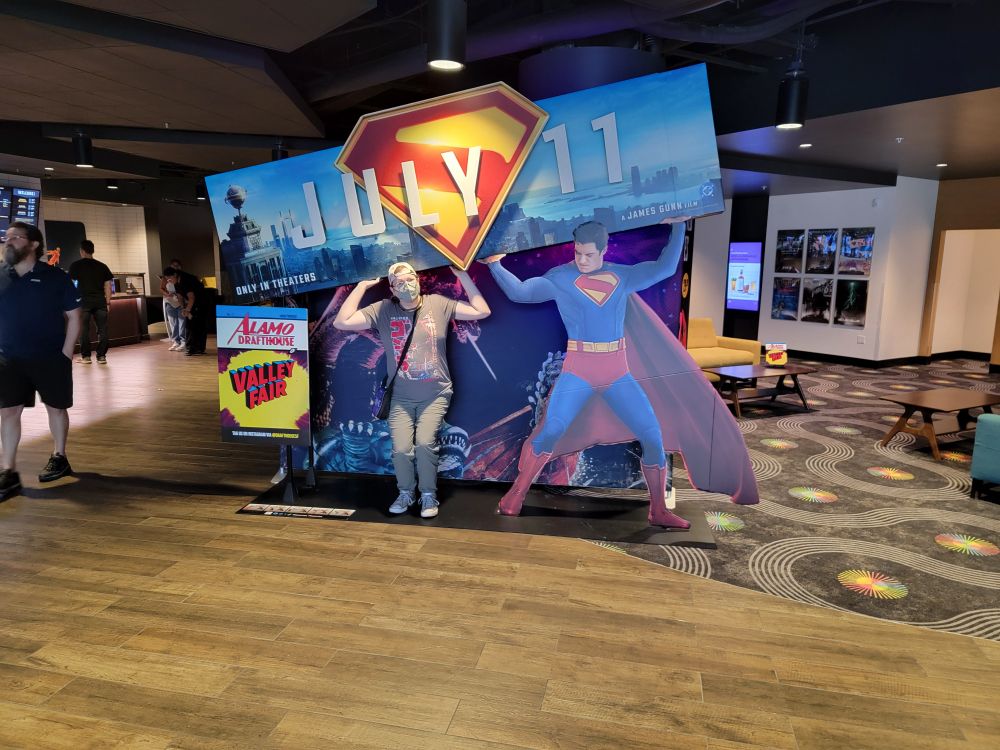 me posing with a sign of superman holding up a sign