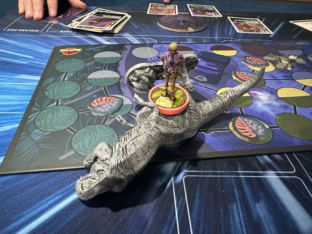 Dr Sattler standing on top of a T Rex after busting its ass