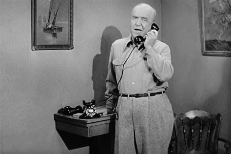 Actor William Frawley answers a telephone in the role of Fred Mertz on the television sitcom, I Love Lucy.