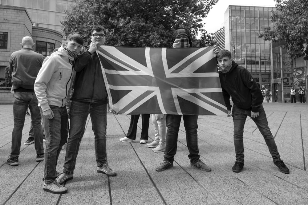 Four young men with a union flag