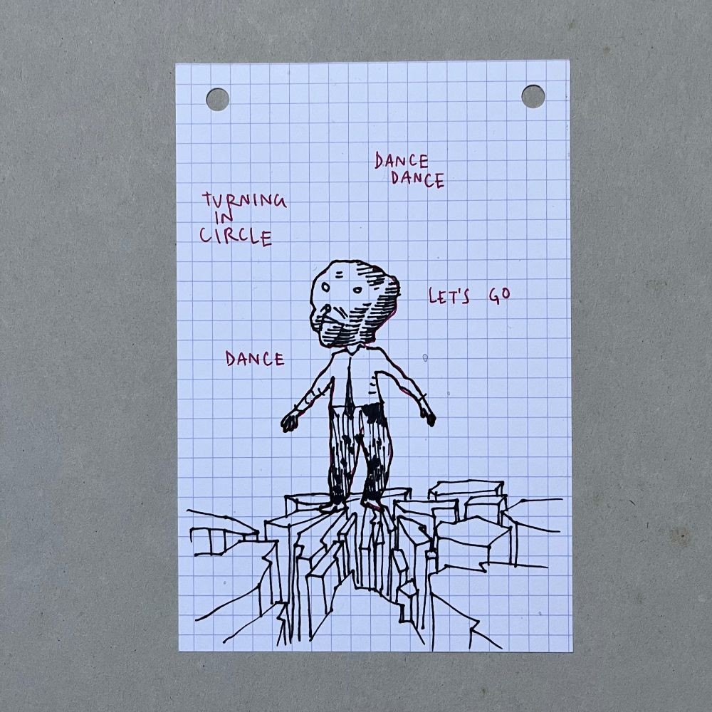 A series of four drawings on  index card. Each one is showing a man on the top of a cliff. He’s wearing an oversized mask that looks like a ventriloquist’s puppet, dressed with a white shirt and a black tie. He’s alone, surrounded by what seems to be instructions to dance : Shake your shoulders, lift your arms up, move your feet, tap your feet clench your teeth, turning in circles, let’s go