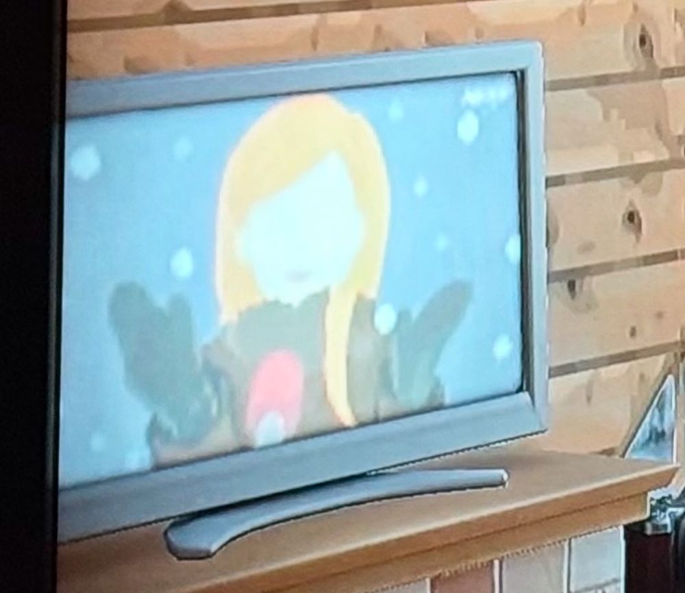 Close up of animal crossing television with Zenos yae Galvus talking into a red microphone.  It’s snowing in the scene because she is obviously in garlemald 
