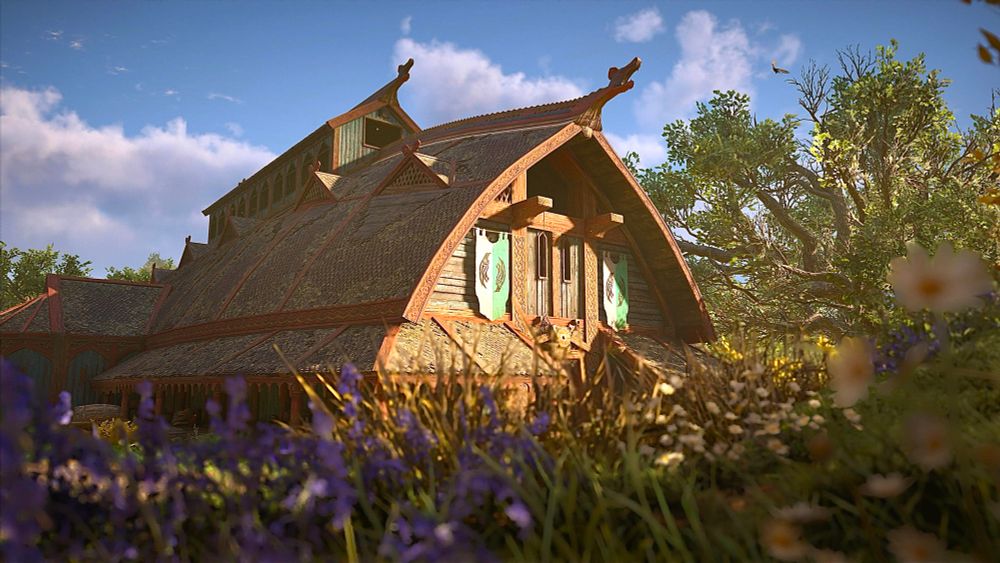 Out of focus flowers in the foreground with a large Viking hall in the background.