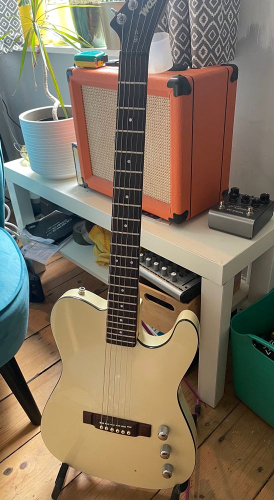 A Washburn SBT-21 in front of an Orange Crush amp 