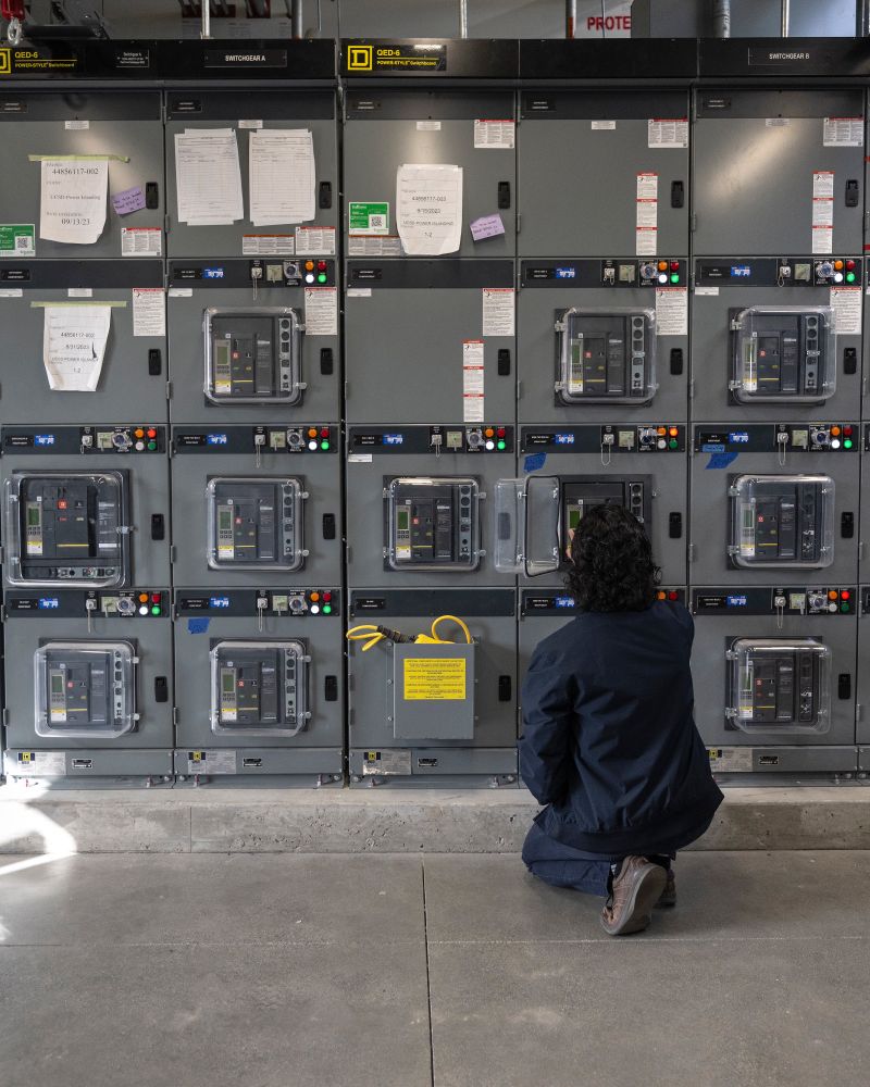 An engineer checks research braker boxes