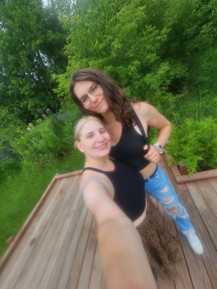 A selfie of Brooke and paige in front of trees