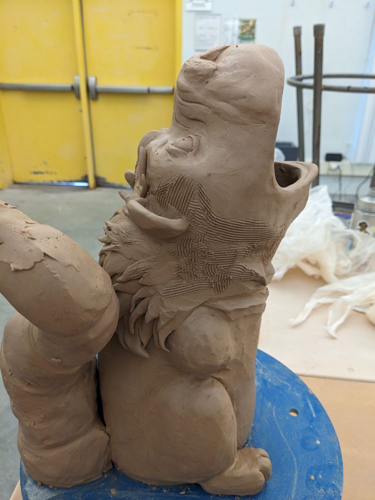 Angle view of a Manticore made of clay 