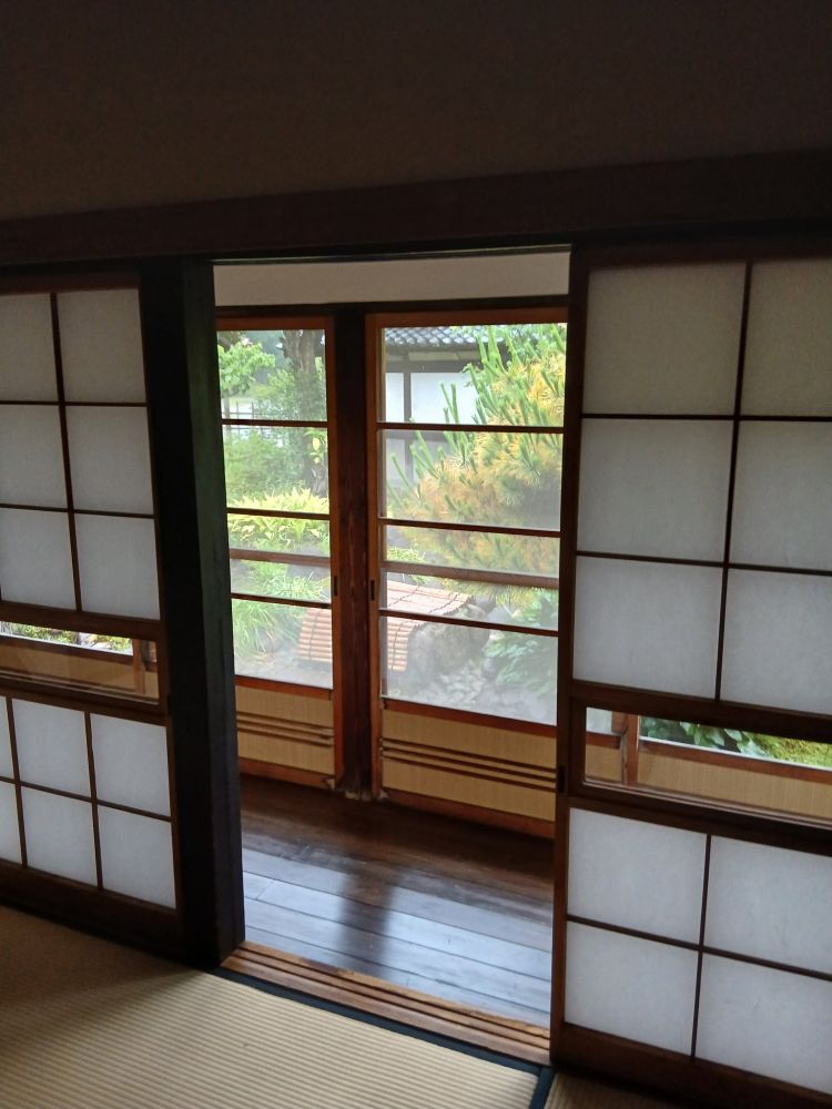 An interior view inside the teahouse overlooking a doorway, corridor, and window 