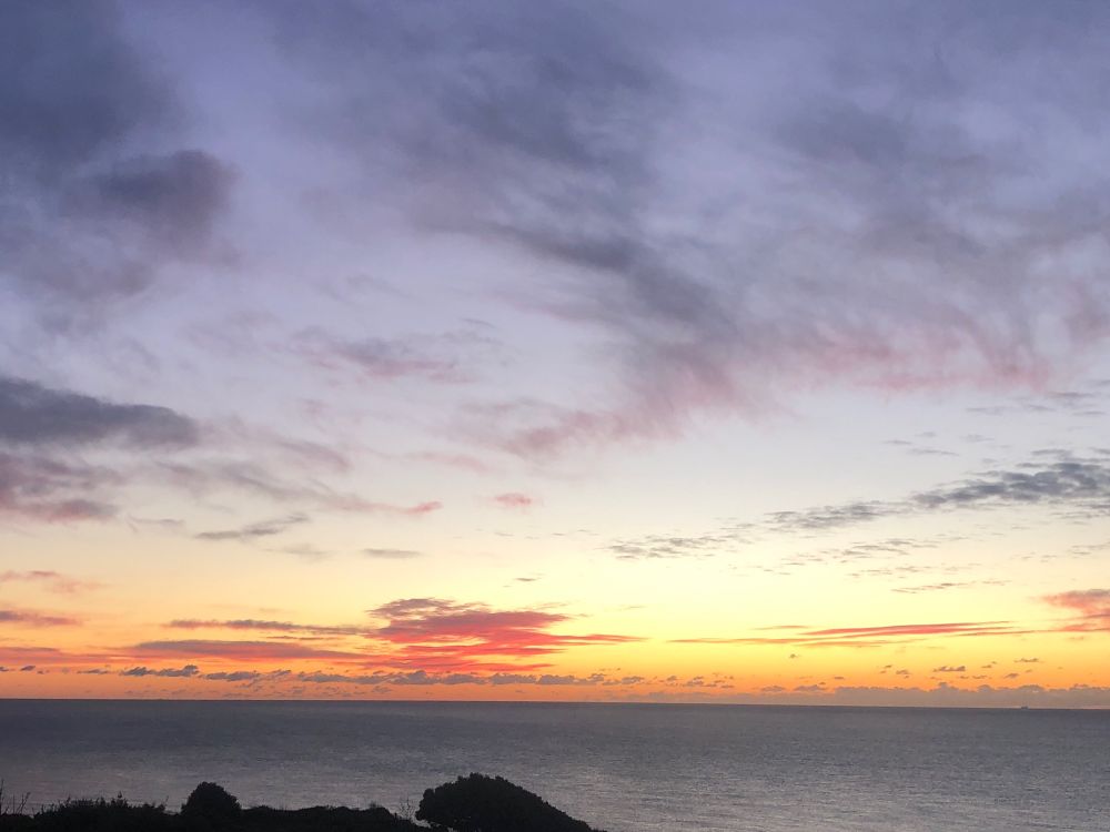 Orange horizon as the sun rises over the sea