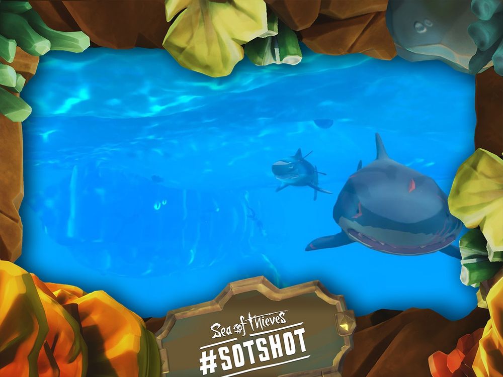 A framed screenshot of Sea of Thieves showing a swarm of sharks being followed by a huge Megalodon.