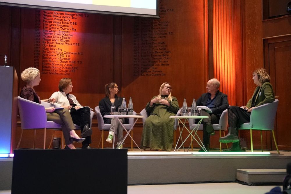 Picture of panel at event on a stage. Chaired by Cathy Newman, guests included: Domestic Abuse Commissioner for England and Wales, Nicole Jacobs; David Miles from Meta ; Emma Pickering from Refuge; Author and TV personality, Georgia Harrison; and Ofcom’s Jessica Smith.
