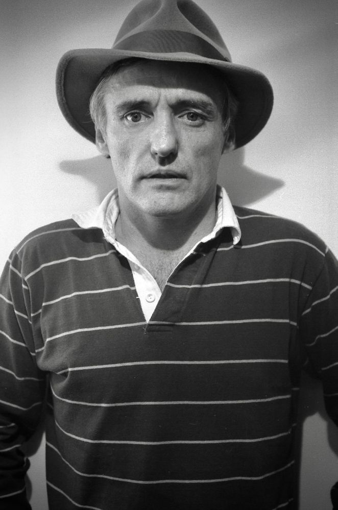 Dennis Hopper in a striped shirt and trilby.