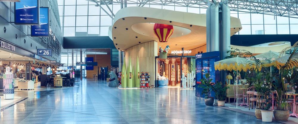 A view of the gate area in Helsinki Airport, with a Moomin shop, complete with a Groke and some Hattifatteners, prominently visible.