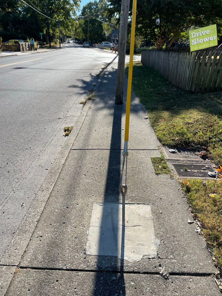 Telephone pole in a sidewalk 