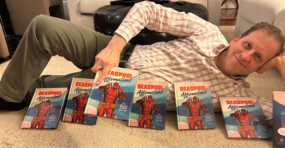 The author posing like Deadpool with his upcoming Deadpool book.