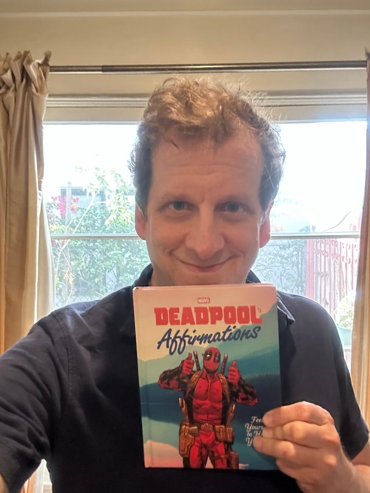 Author holding his upcoming book “Deadpool: Affirmations”