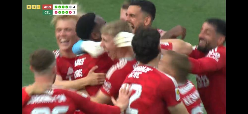 Dimitar Mitov finds that the save was deemed ok by VAR, and is mobbed by jubilant teammates.