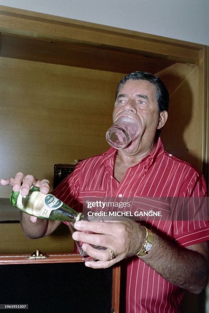 Star of the Day the Clown Cried and the King of Comedy actor singer and comedian and star Jerry Lewis he has a hotel clear hotel tumblr shoved in his fucking mouth and is pretending to pour Pierre water into his hand he's a singer ok people rock and roll photos