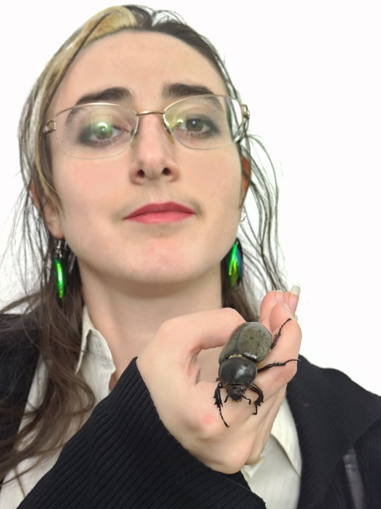 Lady holding the large beetle