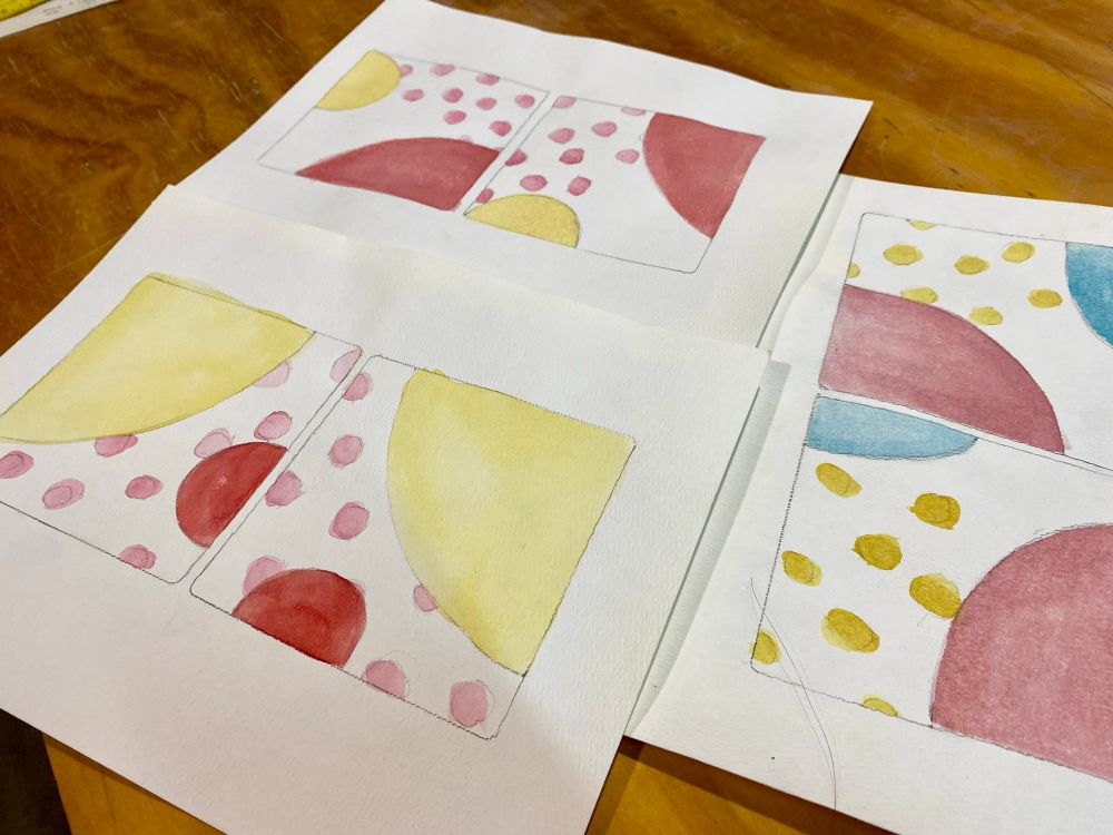 Watercolor sketches of tile designs with bold circles and dots. 