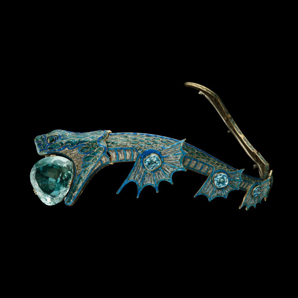 An Art Nouveau enamelled tiara by Georges Fouquet in the shape of a dragon with a large aquamarine in its mouth, designed to wrap around a woman's head