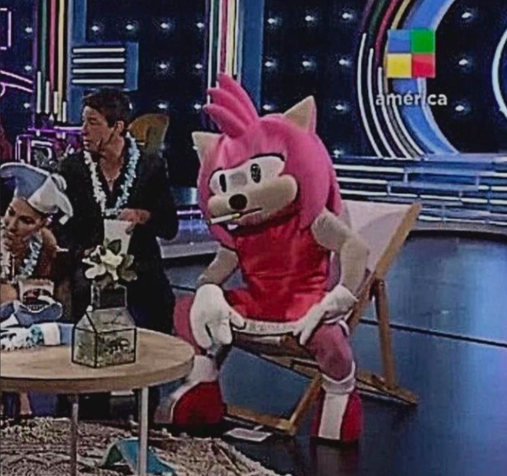 A person in an Amy costume with a cigarette in their mouth looking stressed during a Latin game show. 